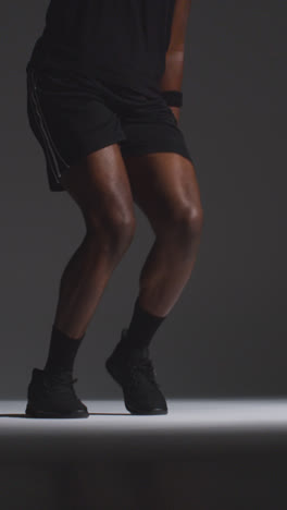 Vertical-Video-Close-Up-Front-View-Studio-Shot-Of-Male-Basketball-Player-Running-Jumping-And-Shooting-Ball-At-Basket